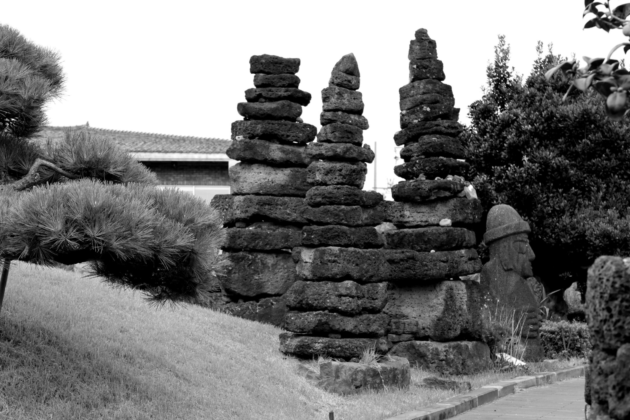 Stone towers and a dol hareubang surrounded by trees